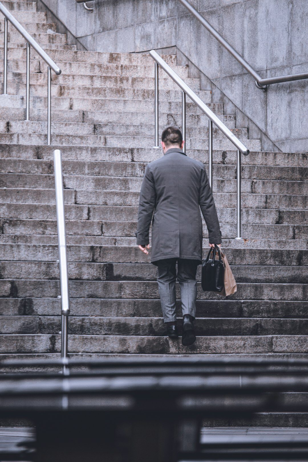 successful businessman climbing stairs
